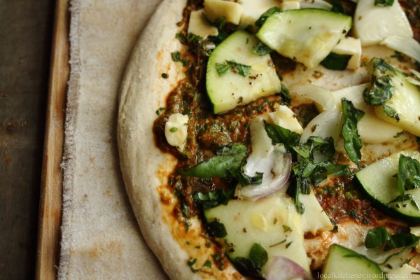 Zucchini Pesto Pizza ready to be baked