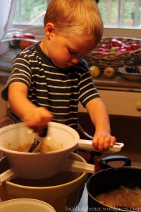 pureeing the applesauce in a food mill